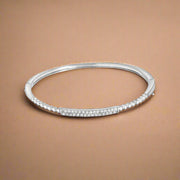 A sterling silver bracelet with cubic zirconia accents.